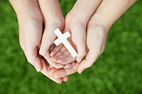 Hands holding cross